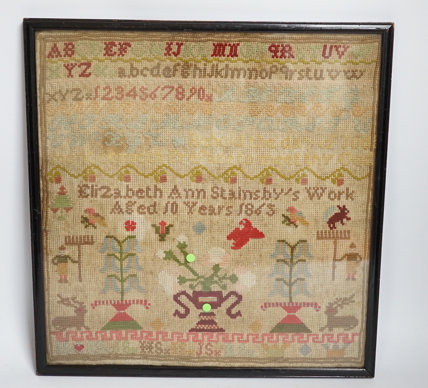 A fine cross stitch needlework sampler, by Sarah Graham, dated Oct 1842, in original frame, 36 x 30cms, and a later wool worked sampler ‘’Elizabeth Ann Stamsby’s Work Aged 10 Years 1865’’ (2)